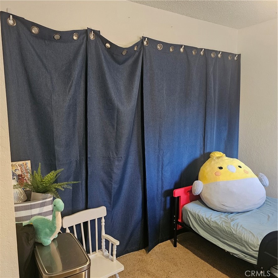 435 West 9th, Unit B3 Upland, CA 91786 - Photo 35 of 71 a bedroom with a bed and wooden floor