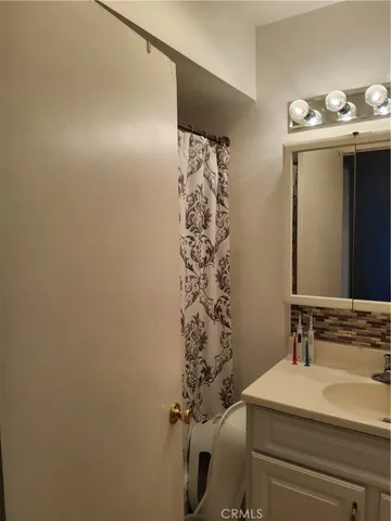 a view of a house with a big yard plants and large trees