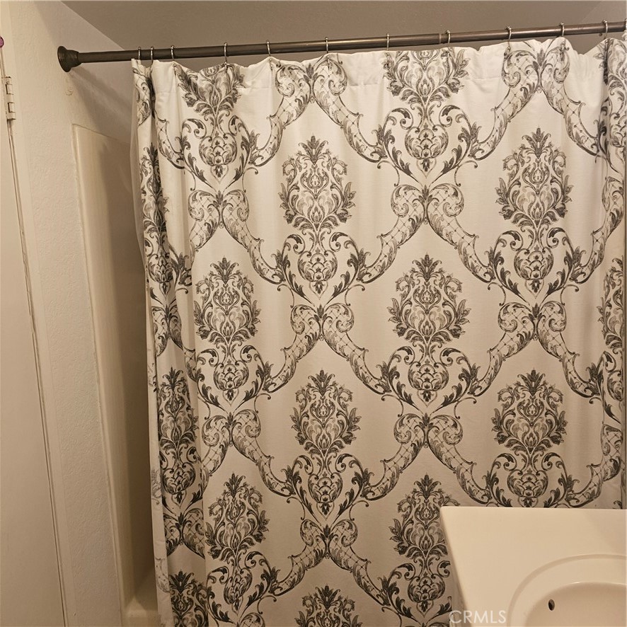 435 West 9th, Unit B3 Upland, CA 91786 - Photo 40 of 71 a bathroom with a toilet and a shower curtain