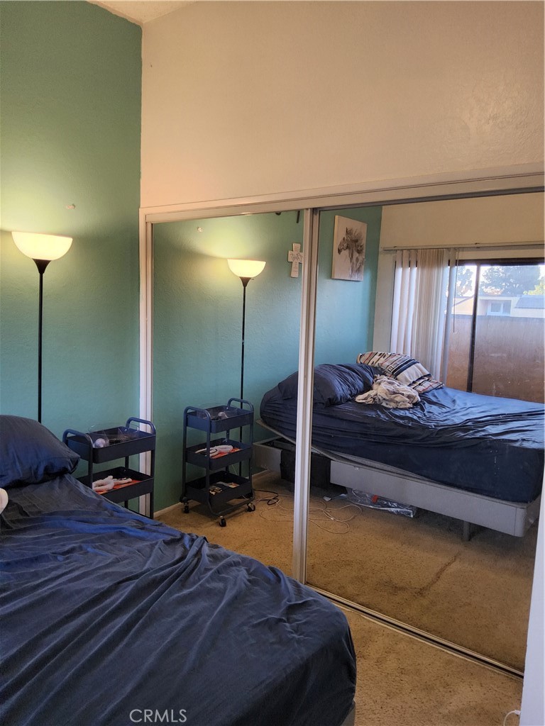 435 West 9th, Unit B3 Upland, CA 91786 - Photo 44 of 71 a bedroom with a large bed and a chandelier