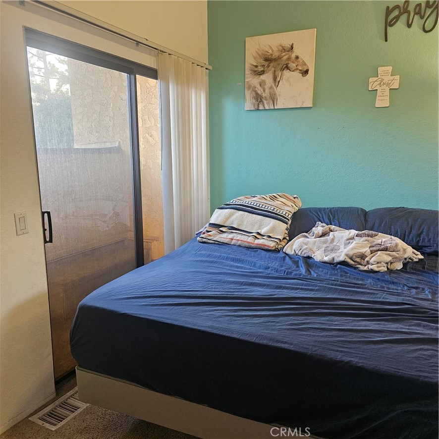 435 West 9th, Unit B3 Upland, CA 91786 - Photo 46 of 71 a bedroom with a bed and painting on the wall