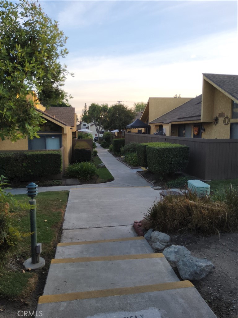 435 West 9th, Unit B3 Upland, CA 91786 - Photo 69 of 71 a front view of a house with a yard