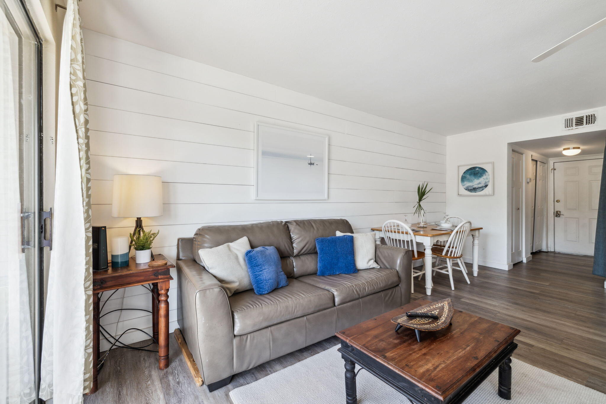 145 Beachfront Trail, Unit 102A Santa Rosa Beach, FL 32459 - Photo 15 of 33 a living room with furniture a dining table and a potted plant