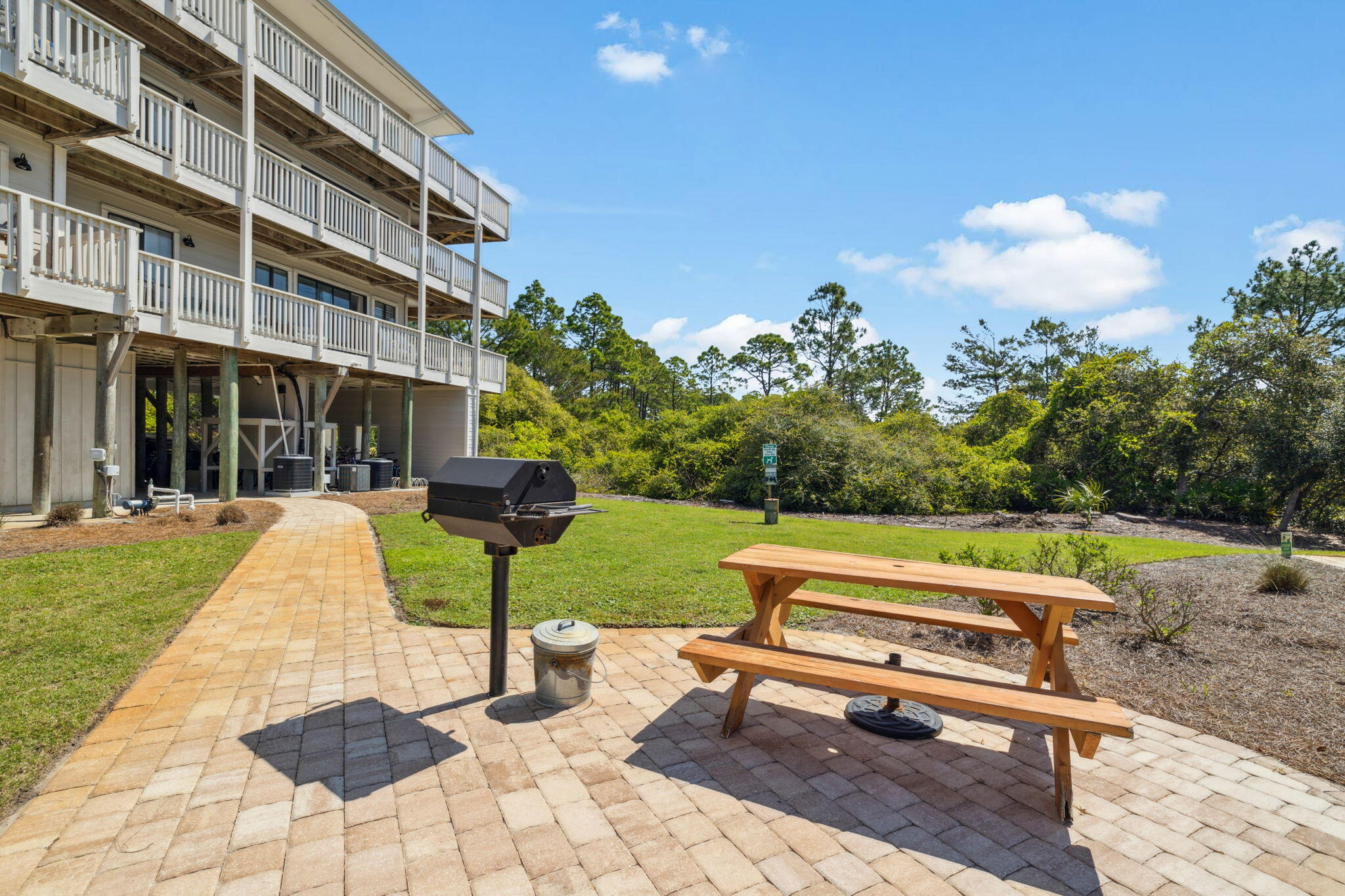 145 Beachfront Trail, Unit 102A Santa Rosa Beach, FL 32459 - Photo 28 of 33 a view of a bench sitting in the backyard of a house