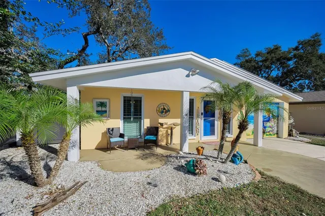 a view of a house with backyard porch and sitting area
