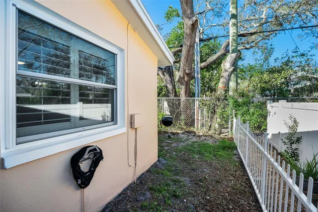 a room with wooden floor pool table and chairs