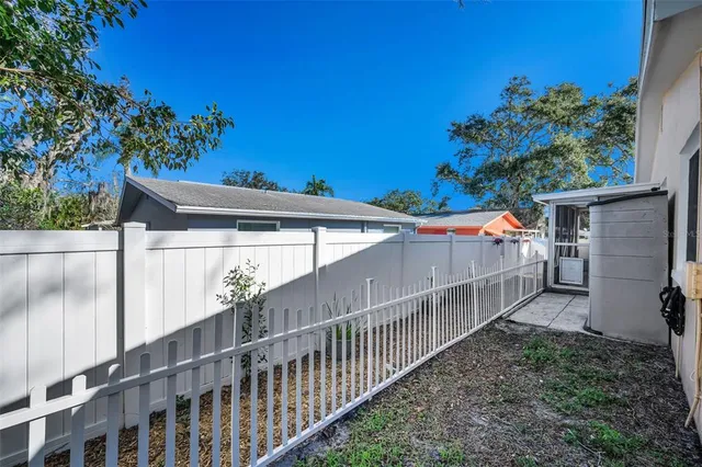a large kitchen with stainless steel appliances a large counter top and a wooden floors