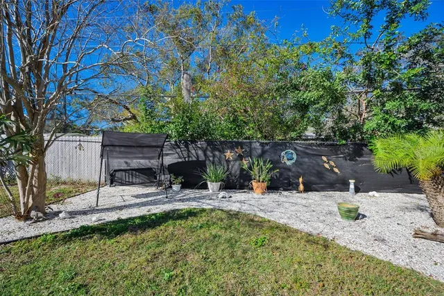 a large white kitchen with a lot of counter space and wooden floor