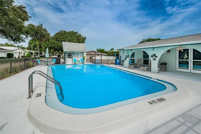 a view of a patio with table and chairs under an umbrella