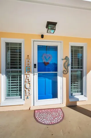 a living room with furniture a dining table and a painting on the wall