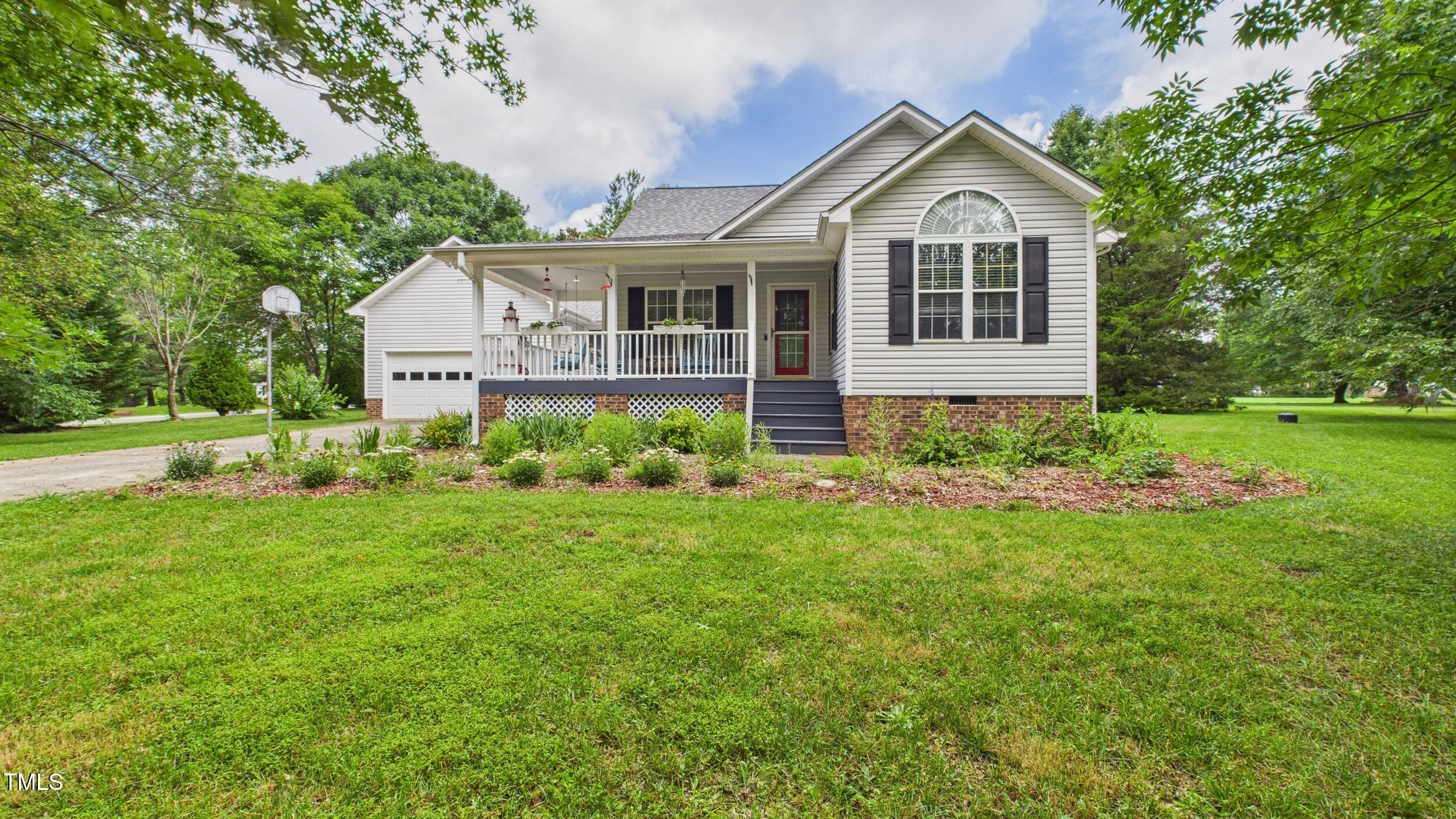 a view of a house with a big yard and garden
