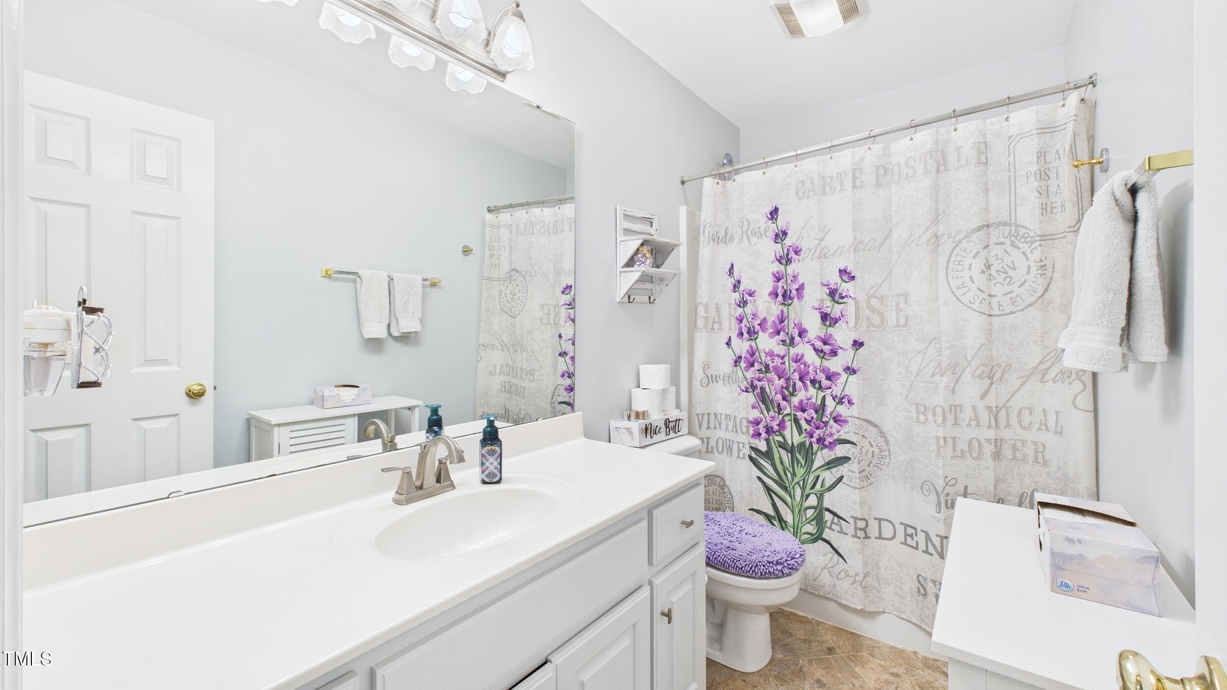 5309 Meadow Field Drive Mebane, NC 27302 - Photo 16 of 41 a bathroom with a sink a toilet and a shower curtain