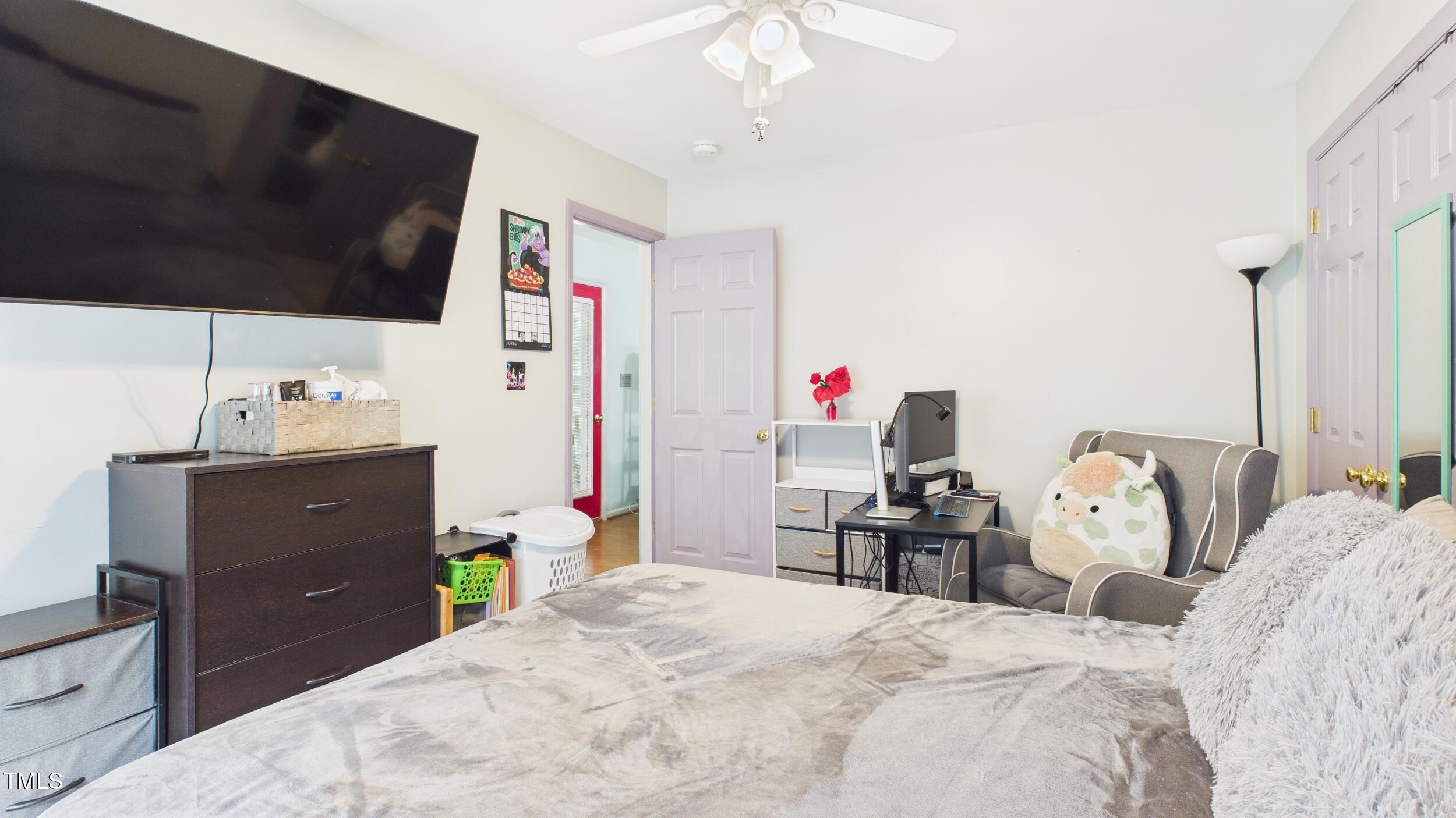 5309 Meadow Field Drive Mebane, NC 27302 - Photo 17 of 41 a bedroom with a bed and a flat tv screen on dresser