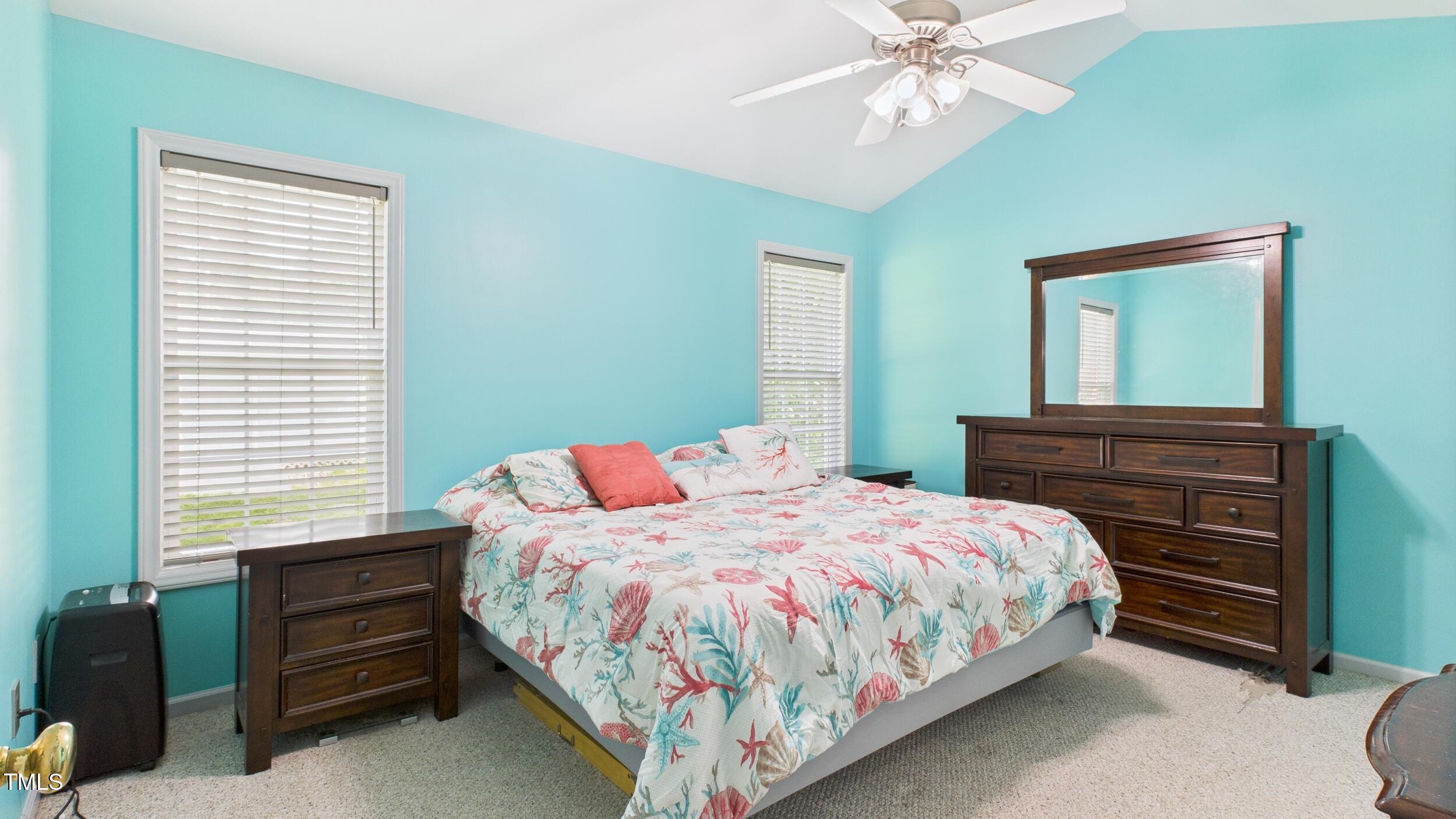 5309 Meadow Field Drive Mebane, NC 27302 - Photo 18 of 41 a bedroom with a bed and a chandelier