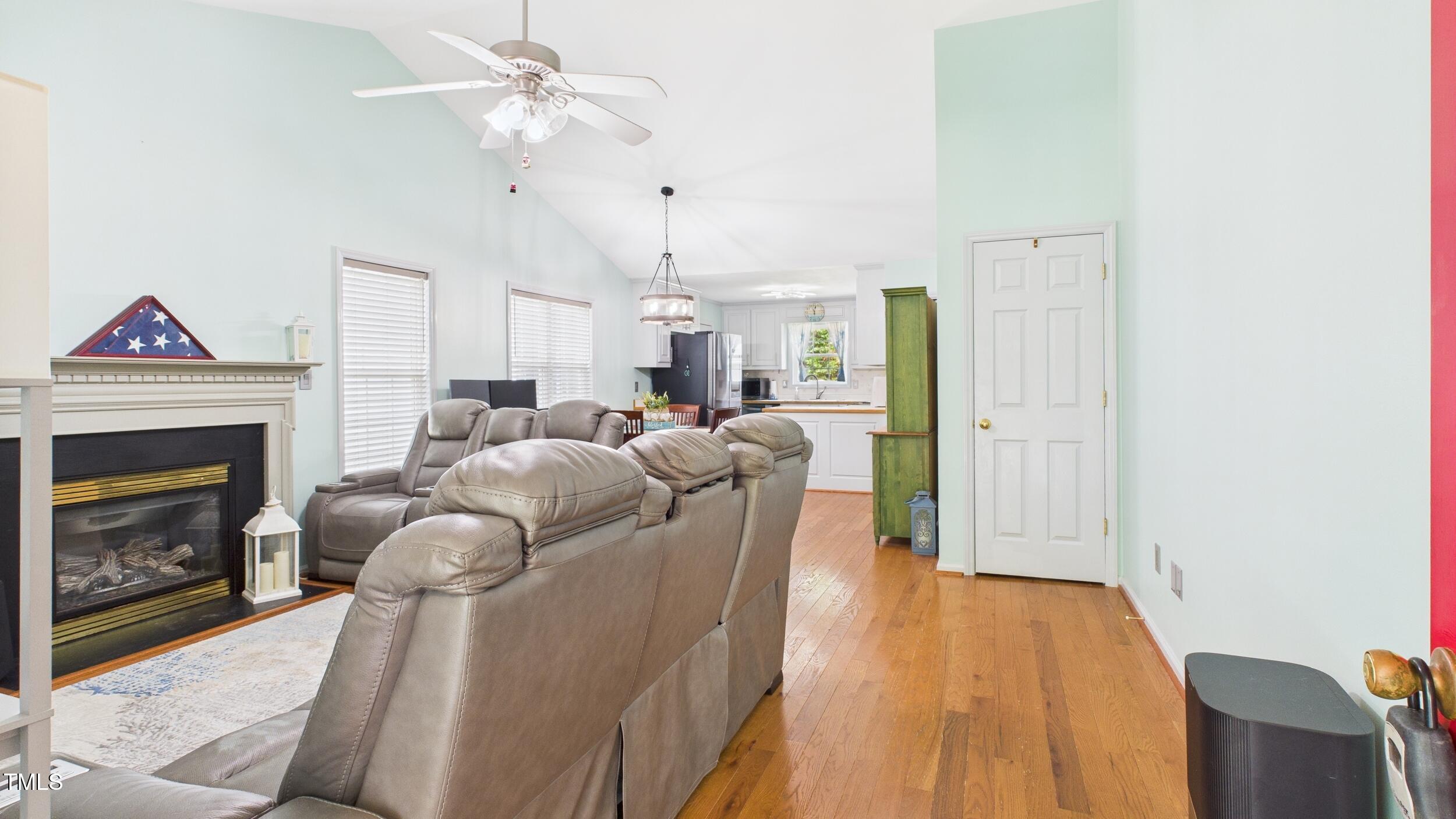 5309 Meadow Field Drive Mebane, NC 27302 - Photo 10 of 41 a living room with furniture a fireplace and a ceiling fan