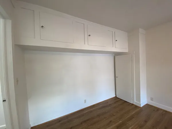 a view of an empty room and wooden floor