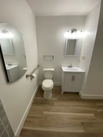 a bathroom with a toilet sink and mirror