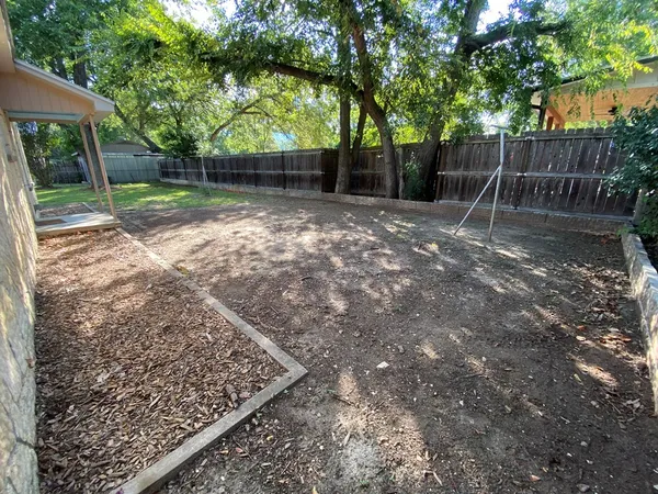 a backyard of a house with lots of green space