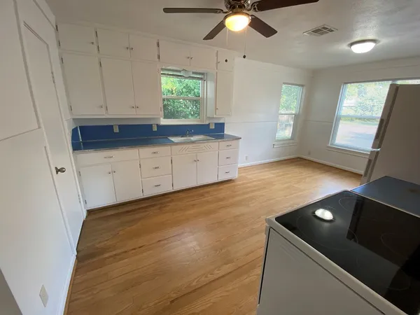 a kitchen with granite countertop a stove a sink and a granite counter tops