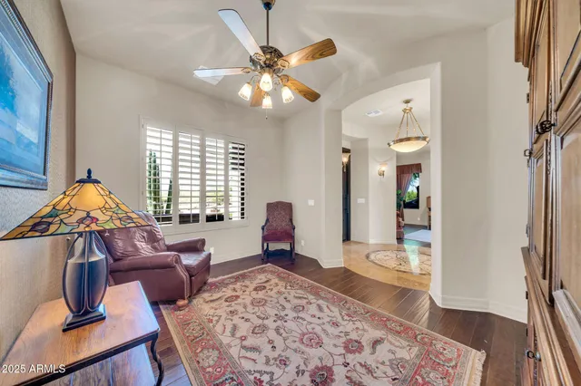 a view of a hallway with wooden floor and door