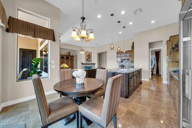 a view of a dining room with furniture and a chandelier