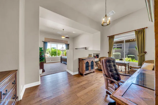 a living room with furniture a fireplace and a large window