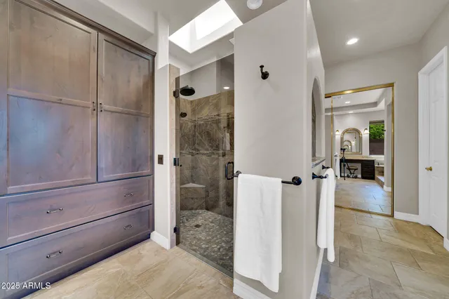 a bathroom with a tub and glass door