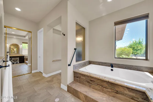 a large bathroom with a granite countertop sink mirror and shower