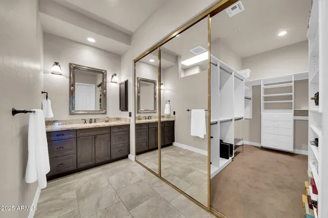 a view of walk in closet with clothes and shoes
