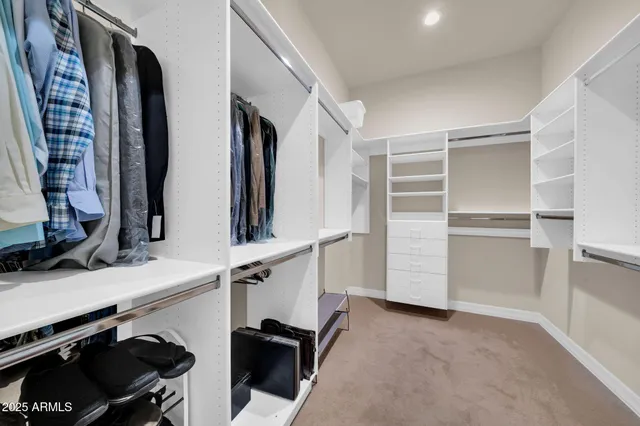 a view of hallway with stairs and wooden floor