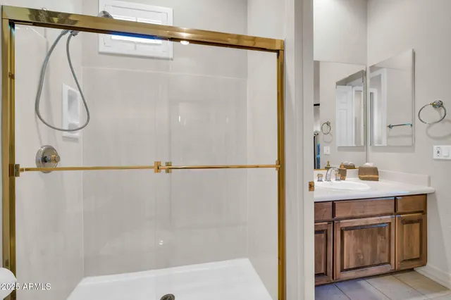a bathroom with a sink double vanity and a mirror