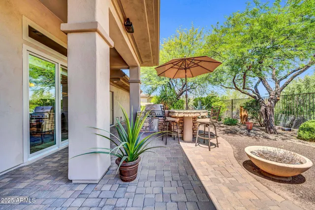 an outdoor space with furniture and umbrella