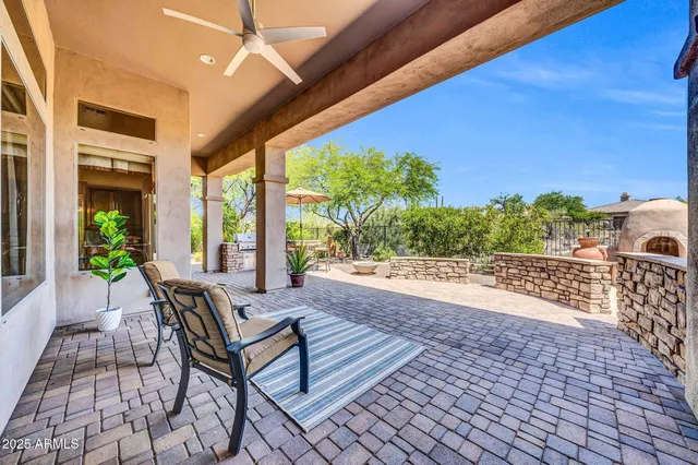 a view of a patio with table and chairs and potted plants