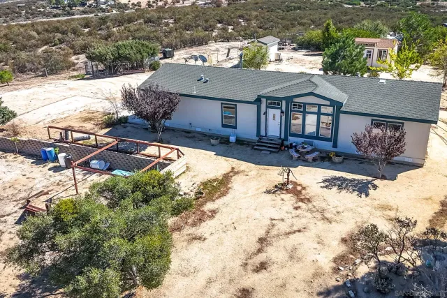 an aerial view of a house with a yard