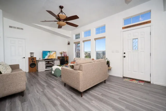 a living room with furniture and a wooden floor