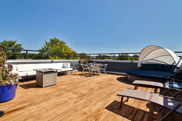 a view of a roof deck with a patio