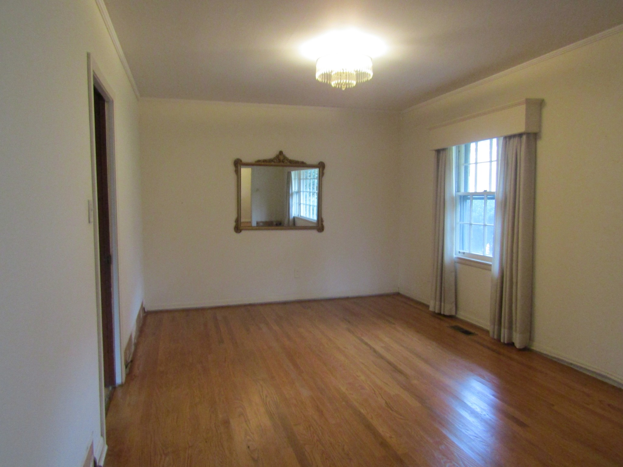 106 Sunset Drive Pulaski, TN 38478 - Photo 7 of 20 an empty room with wooden floor and windows