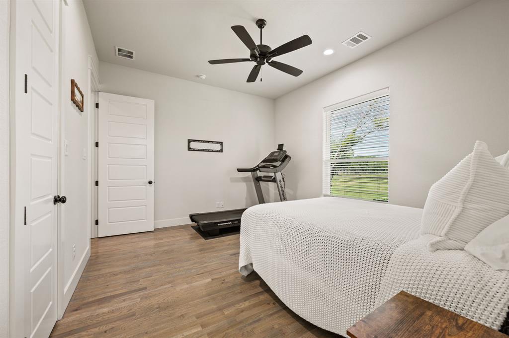 200 Clayton Crossing Springtown, TX 76082 - Photo 29 of 40 a bedroom with a bed and a large window with the outer view