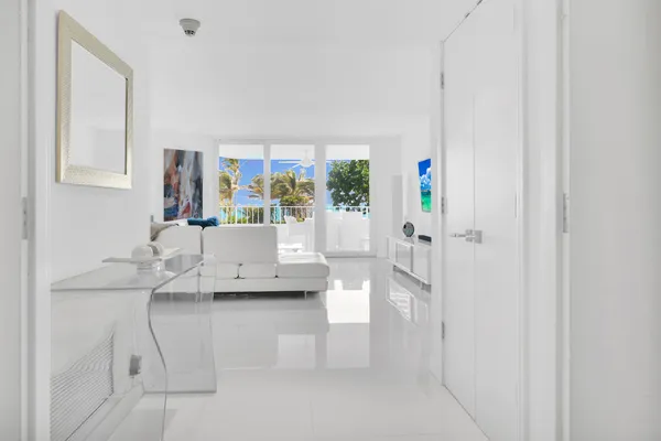 a living room with furniture and a painting on the wall