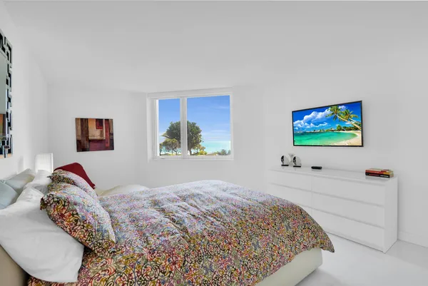 a bedroom with a bed and dresser