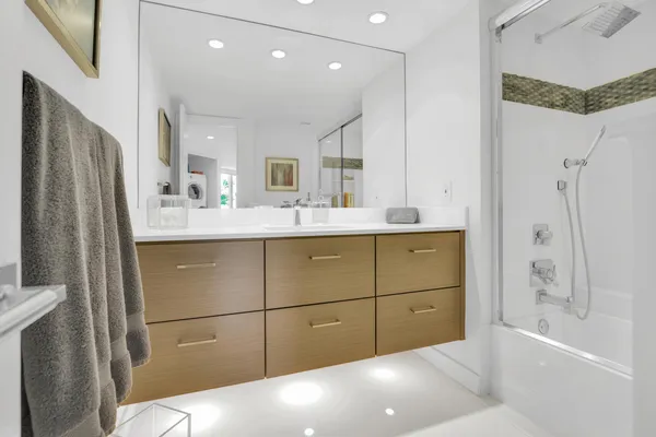 a bathroom with a sink a toilet and shower