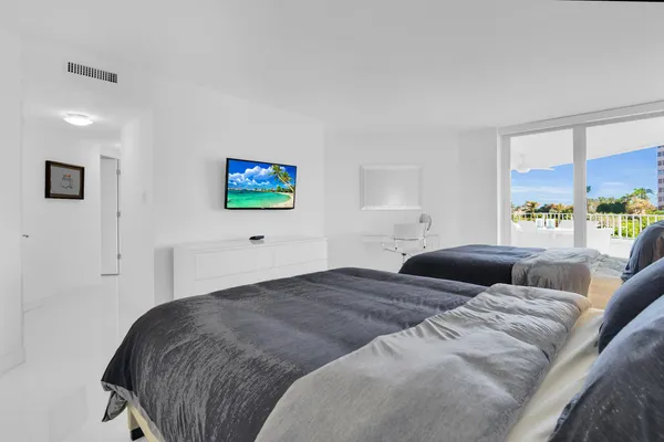 a bedroom with a bed and a couch