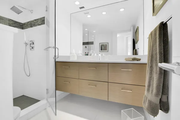 a bathroom with a shower sink and mirror
