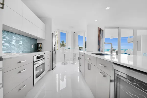 a kitchen with stainless steel appliances kitchen island granite countertop a sink and cabinets