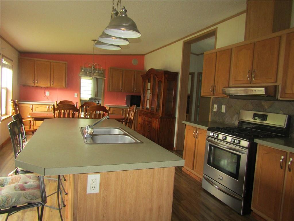 521 Williams Street Confluence, PA 15424 - Photo 5 of 38 a kitchen with stainless steel appliances granite countertop a sink a stove and a refrigerator