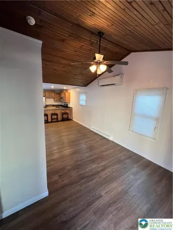 a view of a room with wooden floor