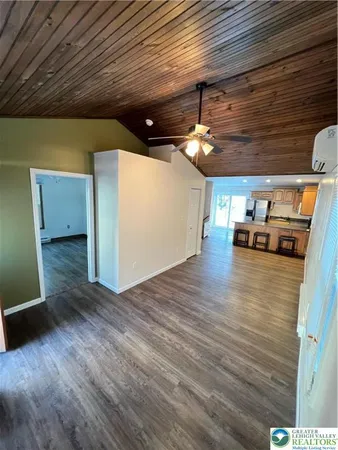 a view of a room with wooden floor