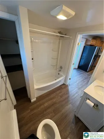 a bathroom with a tub and shower