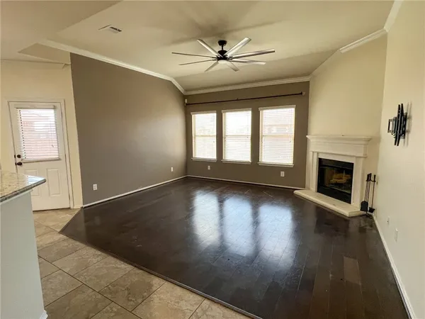 wooden floor in an empty room with a fireplace