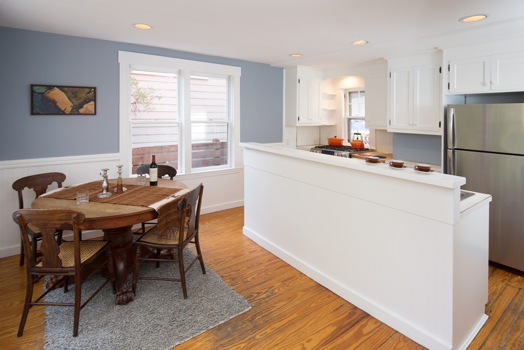 20 Maynard Place Cambridge, MA 02138 - Photo 5 of 10 a kitchen with a dining table chairs and refrigerator